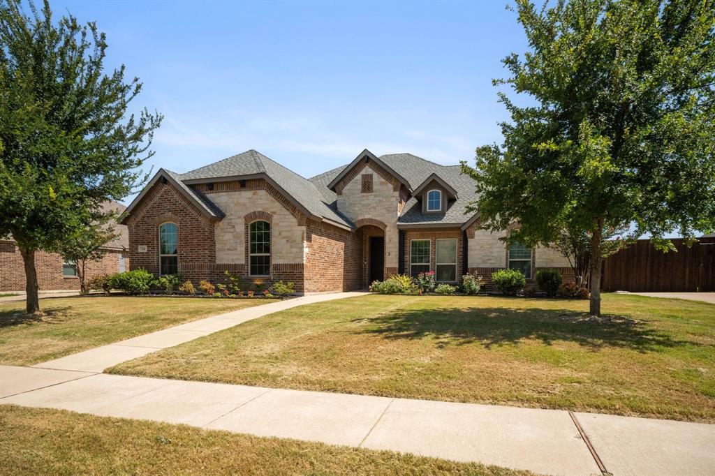 Custom built Waxahachie home with flexible spaces, natural light, and a private gated community. This thoughtfully designed 3 bedroom home includes a dedicated office, two separate living areas, giving you room to work, relax, entertain, or create a playroom that grows with your needs. Large windows brighten the main living room, showcasing custom built ins and a cozy fireplace that anchors the heart of the homes. The open concept flow connects the living, dining, and kitchen areas, making everyday routines and hosting effortless. A split bedroom layout provides privacy for the primary suite, complete with dual vanities, a spacious walk-in closet, and a separate tub and shower for comfortable daily living. Step outside to a fenced backyard with a covered porch that looks out the greenbelt; perfect for quiet mornings, weekend grilling, or unwinding outdoors. Roof and carpet  replaced in 2025, adding peace of mind and fresh updates. 3 car garage and expanded driveway gives extra space for your vehicles. Located in sought after gated subdivision, within walking distance of Felty Elementary and just minutes from local shopping, dining, and healthcare. Must See!!