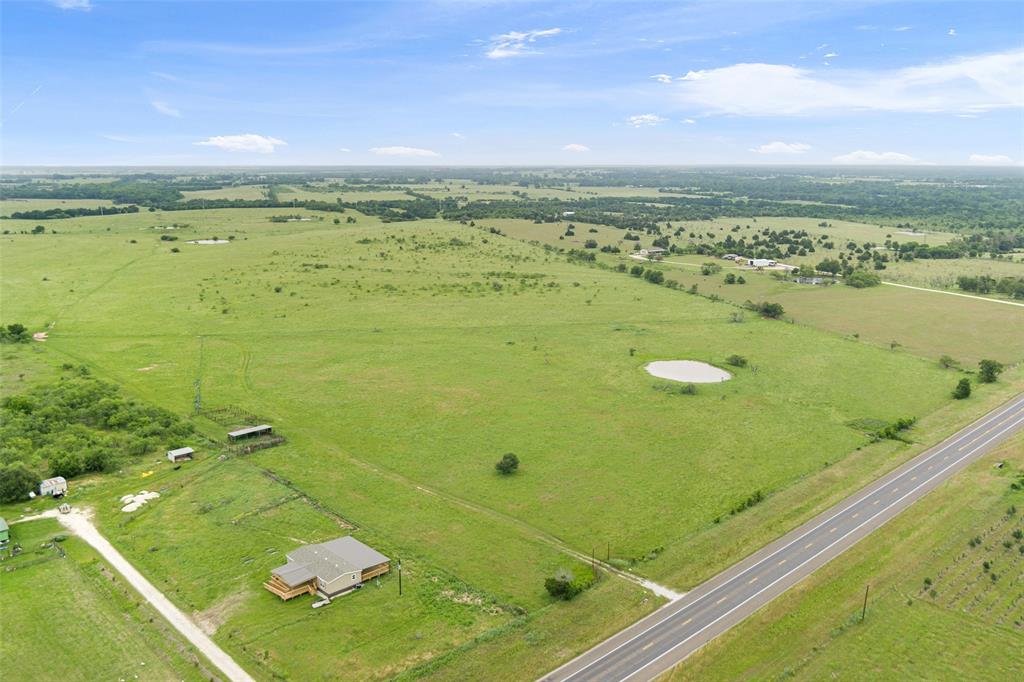 ±9 acres to be surveyed out of a 19.552-acre tract located just outside the Groesbeck city limits. This mostly level pasture tract includes an entry gate and loafing shed, providing a functional setup for livestock or equipment storage. The property is perimeter fenced and well suited for a custom homesite, small ranch, or recreational use.

Seller will retain approximately 0.552 acres, with the remaining acreage divided into two separate tracts. Final boundaries and legal description to be determined by new survey.

Property is subject to use restrictions, including mobile homes limited to 10 years old or newer and limitations on temporary structures and commercial animal operations. Seller reserves all mineral rights owned, if any.