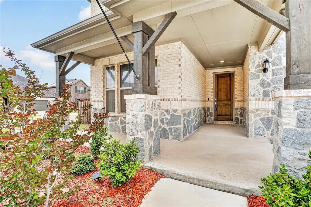 Stunning one-owner 2021 brick and stone home on a PRIME CORNER LOT in the sought-after, amenity-rich Berkshire Community within highly acclaimed Northwest ISD. Designed for comfort, function, and entertaining, this home features an open-concept layout where the kitchen, eat-in area, and living room flow seamlessly together. The inviting living room showcases soaring ceilings and a warm fireplace, while the spacious kitchen offers a large center island, dry bar, gas cooktop, stainless steel appliances, and dining space ideal for gatherings. A formal dining or flex space near the entry adds valuable functionality with convenient kitchen access. The thoughtfully designed floor plan includes a first-floor primary suite with sitting area, dual sinks, garden tub, separate shower, and two walk-in closets. A first-floor secondary bedroom near a full bath offers flexibility for guests, multi-generational living, or office use. Upstairs offers a HUGE game room, separate media room pre-wired for sound, convenient half bath, two spacious bedrooms, and full bathroom. Enjoy both a spacious covered front porch and an extended 26’ x 8’ covered back patio with two electrical outlets and a gas line hookup, perfect for BBQs or relaxing outdoors. Berkshire residents enjoy a community pool, amenity center, gazebo, playground, and walking trails. Ideally located minutes from parks, major highways, Alliance Town Center, Presidio Towne Crossing, shopping, dining, and H-E-B. Approximately 15 minutes to Downtown Fort Worth and 26 minutes to DFW Airport. Solar system keeps power bills under $60 with estimated savings of $450-$500 per month. This home offers the perfect blend of flexible living spaces, suburban tranquility, modern convenience, and energy-efficient living. Schedule your private tour today.