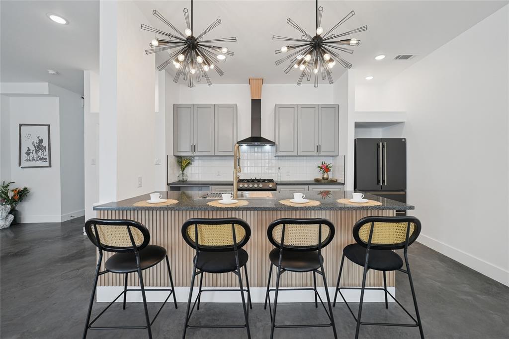 Modern new construction condominium in the heart of East Dallas, with 3 bedrooms and 2.5 baths. The striking exterior combines white siding with black metal accents for sleek, contemporary curb appeal.

Inside, double-height ceilings and a statement staircase create an impressive entry. The open-concept first floor offers a spacious dining area and a beautifully designed kitchen with stunning black appliances, perfect for everyday living and entertaining.

Upstairs, a flexible loft with built-in cabinetry provides space for a bar, office, or lounge. The spacious primary suite includes a spa-like bath with double vanities, walk-in shower, and walk-in closet, with direct access to the laundry room for added convenience. Two additional bedrooms complete the second level.

Enjoy the backyard and balcony for seamless indoor-outdoor living. Ideally located just minutes from Downtown Dallas with easy access to major highways, restaurants, shopping, and entertainment, offering the perfect blend of modern design and urban convenience.