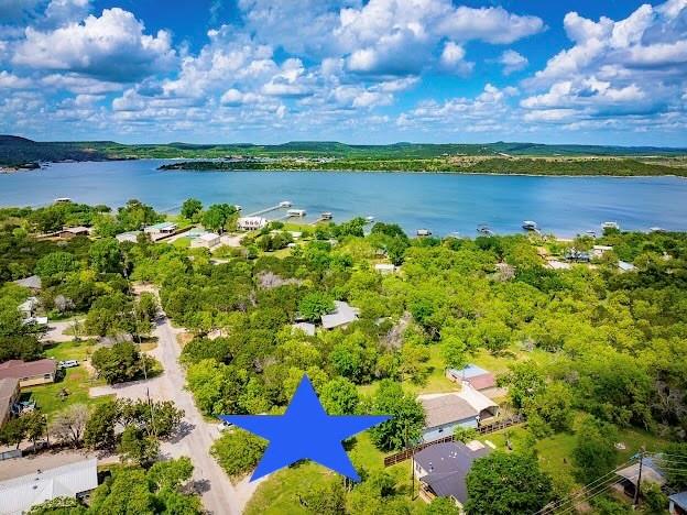 BEAUTIFUL FURNISHED 3BD, 2BA LAKEHOUSE in a PRIVATE, PARK LIKE, PK LAKE SETTING amongst Mature Shade Trees and a Large Grassy Lawn, with a Screened In Porch, 2 Car Carport, Boat Storage with automatic Door and a Workshop. This Charming 2021 Home Features an Open Concept Design with Wonderful Picture Windows throughout, a Chef's Kitchen with Stainless Appliances, Granite Counters and Eat In Kitchen Island, Spacious Living and Dining Areas for Entertaining Friends and Family, a Built in Office Space for work from Home, and a Large Laundry and Mud Room with a door to outside. All this and only .25 mile away from Boat Ramps to launch your Boat or Jet Skiis for Fantastic Lake Fun & Fishing, on Possum Kingdom Lake. This is the BEST of PK Lake Living with plenty of room to Relax and Recharge whether inside, or on the Screened Porch or outside Playing Yard Games, or sitting in the Yard just to gaze at the TX Starry Skies at night. Don't miss this one, it's a true Piece of PK Paradise, and TURN KEY READY. Can also be Overnight Rented.
