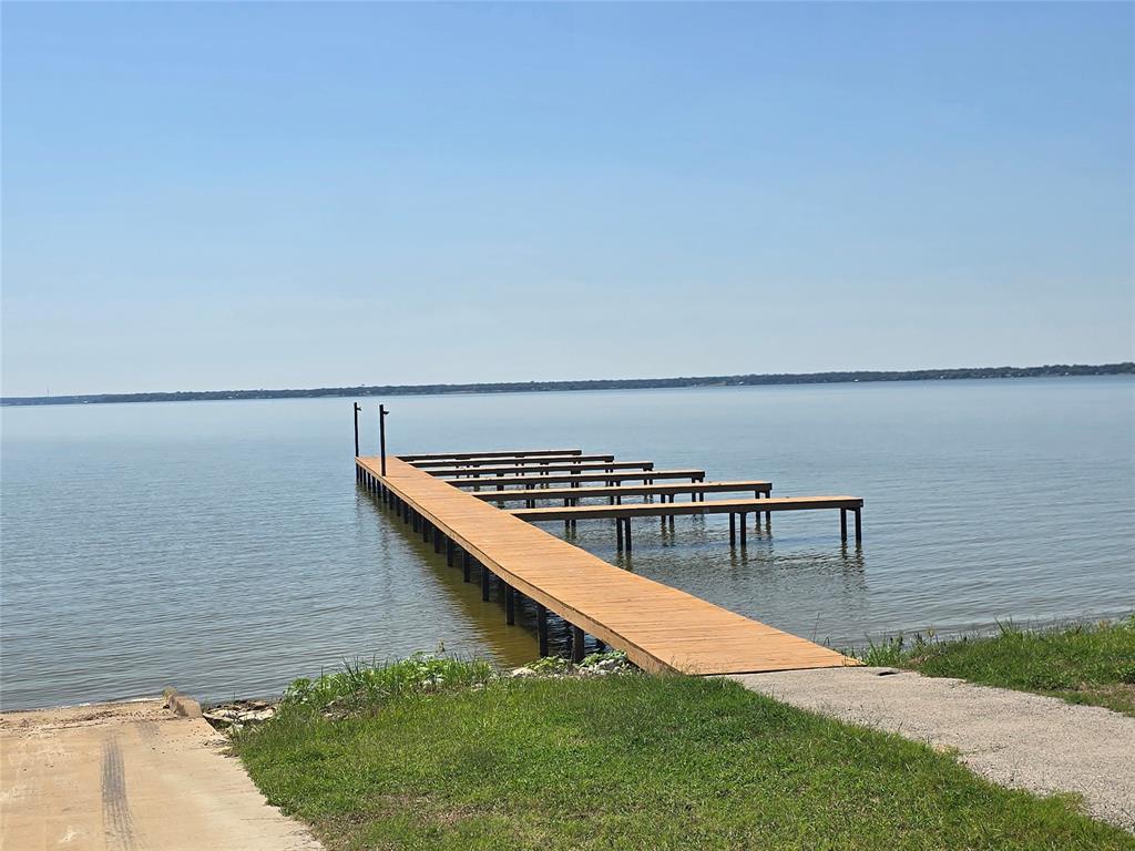 Build your dream home in this sought-after community, offering resort style living and first class amenities.  This oversized 100x300 homesite provides plenty of space for your vision, with mature trees along the back for added privacy.  Enjoy access to a million-dollar amenity center featuring an infinity pool, a community dock for lake access and the peace of mind that comes with a gated neighborhood.  This is an amazing opportunity to secure a spacious lot in a premier waterfront community.