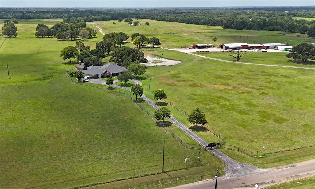 Sought-after Wills Point ranch just 45 minutes from Dallas – a rare blend of history, opportunity, and modern ranching lifestyle! Own a piece of Texas heritage surrounded by 300+ year-old trees, including the iconic Lady A, a 400+ year-old oak. This fully operational AG exempt ranch is set up for immediate use with 4 barns, multiple corrals, working pens, and cross-fenced pastures ideal for rotational grazing of cattle or horses. The ranch features 10 ponds, a fenced alleyway for efficient livestock movement, and a vet area with access to water and electric. The expansive barn includes an air-conditioned office, half bathroom, and washer& dryer, making operations convenient. The 3,192 SF main home offers luxury and comfort with serene views and thoughtful design throughout. Entertain with ease on the outdoor patio, featuring a covered kitchen, wood-fired pizza oven, and space to dine or dance under the stars. There's even an outdoor bathroom with AC for guests. Explore your land via ATVs or horses and enjoy breathtaking Texas sunsets.

Additional highlights:
Attached outdoor arena for riding or events
Multiple barns and equipment sheds
Farming equipment available for purchase
3 Additional homes and approximately 8 acres can also be purchased, ask agent for details

This property offers endless potential—from ranching and equestrian pursuits to agri-tourism, events, or private retreat living. Whether you're expanding your operation or embracing a new chapter in country life, this one-of-a-kind ranch is ready for you. Inquire with REALTOR regarding established interest with adjoining property owners to assemble the lots for optimum road frontage on CR 3910. This would be 3 additional lots for a total of 8.4 acres.