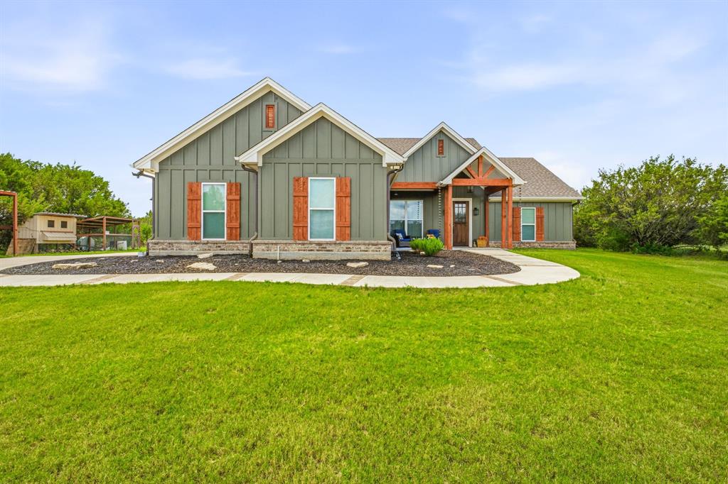 Charming Modern Farmhouse privately situated on 2 secluded acres, offering the perfect blend of comfort, style, and country living. Step inside to an open-concept floor plan featuring a beautiful shiplap electric fireplace as the focal point of the spacious living area. The well-appointed kitchen offers double ovens, a glass cooktop, farmhouse sink, upgraded appliances, a large island, and a generous walk-in pantry. The primary suite is a relaxing retreat with a soaking tub, walk-in shower, dual sinks, and a spacious walk-in closet. Three additional bedrooms provide plenty of room for family, guests, or a home office. Foam insulation offers year-round energy efficiency and comfort. Enjoy outdoor living on the covered patio, perfect for entertaining, BBQs, and taking in the peaceful surroundings. The property also features an attached 2-car garage, detached 2-car carport, and multiple outbuildings with ample space for equipment, hobbies, and all your toys. Experience the privacy of country living while enjoying the modern amenities and charm this beautiful farmhouse has to offer. Come experience breathtaking Texas sunsets, star-filled skies, and abundant wildlife. Mountain Lakes amenities include a recreational lake, fishing lake, clubhouse, pool, park, walking path, garden, and RV park—country living at its finest!