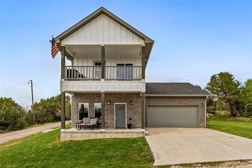 MOTIVATED SELLER—Nestled in the gated Canyon Creek community, this like-new home occupies a prime corner lot, offering spectacular panoramic views of Comanche Peak. The popular neighborhood features a number of amenities, including two pools, a clubhouse, a boat launch, playgrounds, and fishing areas—perfect for an active and vibrant lifestyle. Home offers luxurious open-concept living. Gorgeous luxury vinyl plank flooring flows seamlessly throughout the home.  A modern kitchen boasts sleek quartz countertops, tasteful painted cabinetry, subway tile backsplash, stainless steel appliances, and upgraded lighting and fans. This thoughtfully designed floorplan has a nice primary suite conveniently located on the main level, with a beautiful en suite. Three additional bedrooms (one versatile bedroom or bonus space opens to a private balcony showcasing magnificent views that could serve as a game room, office or tranquil retreat) upstairs. Just minutes from Lake Granbury and Granbury’s charming historic downtown, with boutique shopping, dining, the renowned opera house, and year-round events. Don’t miss this rare opportunity to own a one-of-a-kind home with an unbeatable view in a sought-after community! Schedule your private showing today!