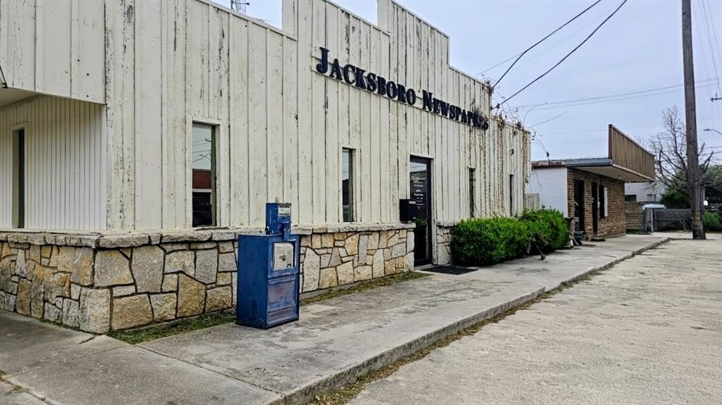 Rare opportunity to own a centrally located commercial property in the heart of historic Jacksboro, Texas. Just steps from the town square surrounded by established businesses, civic offices, & community amenities, this location provides excellent visibility & accessibility within one of the city’s most active commercial corridors. Its walkable to restaurants, retail, professional services, and municipal buildings, making it ideal for businesses seeking strong local presence & convenient customer access. The property is classified as Commercial (NEC), allowing broad flexibility for future use, including retail, office, boutique services, or redevelopment. Its position within the commercial district supports long term value as the area continues to benefit from steady traffic, community events, and ongoing investment in the downtown core. Building sits on well proportioned lot with efficient frontage, offering strong signage potential easy ingress and egress. The structure’s footprint can accommodate open layouts or segmented configurations, supporting a variety of operational needs. Its manageable scale makes it appealing for small business owners or investors seeking a low-maintenance commercial asset. Proximity to Jacksboro’s central square enhances visibility and foot traffic, especially during community events. The surrounding streetscape blends historic charm with functional commercial infrastructure, creating an inviting environment for customers and employees. The location also provides quick access to major routes, including US281 and TX199, connecting Jacksboro to the broader North Texas region. Ample street parking and a walkable downtown layout further improve accessibility. Represents a versatile commercial opportunity in a stable, community oriented market. Its location, classification, & adaptability make it well suited for long term use, leasing, or repositioning to meet evolving business needs. All information deemed reliable but not guaranteed.