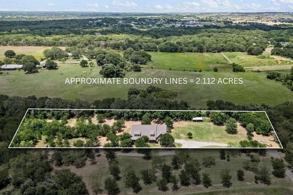 SEARCH YOUTUBE FOR VIDEO OF THIS HOME! USDA Financing Avail! Escape to your own private, tree-filled retreat on more than 2ac in Northwest ISD! NO HOA! Spray Foam Insulation! Radiant Barrier! Move in immediately or pour a little TLC into the home to make it yours! Room on the land to build more structures like a 2nd home, a pickleball court, etc! Unique property w-beautiful mature trees, offering both shade & scenery! The spacious WRAPAROUND covered porch & oversized covered back patio create the perfect setting for sipping coffee, entertaining guests, or simply soaking in the peaceful surroundings! Inside, tall ceilings & a split-bedroom layout give the home an open yet functional feel w-all 4 bedrooms being on the primary level! Not to miss is your ENORMOUS chef-like kitchen w-GRANITE countertops, a HUGE island, an EXPANSIVE breakfast bar area great for entertaining, custom cabinetry w-multiple hidden pullouts, a stainless-steel appliance package, a butler's pantry area, a 5-burner double oven range... all packaged in a design that opens to the family room! The owner’s suite is tucked away from the other bedrooms for added privacy & quietness away from a busy household! It boasts a spa-like en suite & a HUGE owner's closet! The 3 secondary bedrooms all are spacious in size, have ceiling fans, 2-inch blinds & nice sized closets! The upstairs game room is ENORMOUS & provides GREAT flexibility that could easily serve as a 5th bedroom (if needed) as there is a closet & half bath upstairs as well! Also upstairs is your very own MEDIA ROOM! The garage is EXTRA deep (24') easy for truck parking! Enjoy FREE WATER with your own water well filtration system! There's even a chicken coop ready for your backyard hobby farm! And you are just 2 miles from Eagle Mountain Lake & only 4.5 miles to Hwy 287 w-quick access to a Super Walmart, Starbucks, auto shops, a UPS Store, a BRAND-NEW Texas Roadhouse & so much more! This property truly blends rural charm w-everyday convenience!