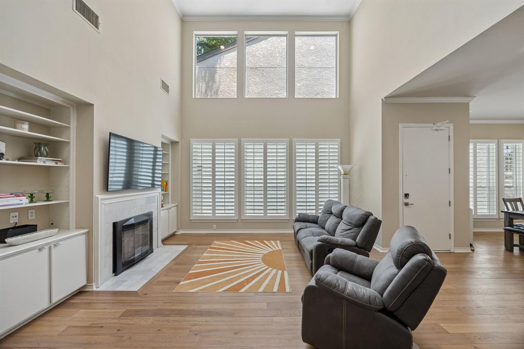 Exceptional lock & leave home in the serene Preston Green neighborhood offers the perfect blend of modern luxe, privacy, and convenience. Zoned award-winning Brentfield Elementary in RISD, this masterfully updated 4-bedroom, 4-BA, three-story home is an art lover's dream with expansive wall space and inspired layout designed for everyday living and effortless entertaining. The highlight of the home is the exquisitely updated kitchen, featuring granite countertops, double ovens, sleek white cabinetry, a large island, and an oversized dining area. Adjacent, the formal dining room overlooks an impressive two-story living room anchored by a wall of windows, soaring ceilings, and an updated marble-surround fireplace flanked by custom built-in cabinetry. The 1st floor hosts a private 4th bedroom with an updated full bath — ideal for guests or multigenerational living. The second floor features a spacious primary suite with dual vanities, a garden tub, and a separate shower, along with two additional bedrooms, each with their own ensuite baths. The larger secondary bedroom functions as a 2nd primary suite. The 3rd floor offers a versatile media room, perfect as a home theater, exercise room, or office. The 2020 renovation included new windows, plantation shutters, fresh paint, updated lighting, solid-core doors, a new garage door and opener, an updated fireplace surround, and hardwood floors on the second and third levels. All bathrooms feature stunning updated finishes, and the upstairs HVAC was replaced in 2018. Perfectly situated directly across from the community's fabulous greenbelt, saltwater pool and grilling area, with HOA coverage including, water, frontyard maintenance and use of community amenities. Close to Preston Ridge Trail, Campbell Green Park, Wagging Tail Dog Park, fine dining, shopping, and major thoroughfares including George Bush Turnpike, Dallas North Tollway, US-75, and LBJ Freeway. This one truly has it all, space, style, and an unbeatable location!