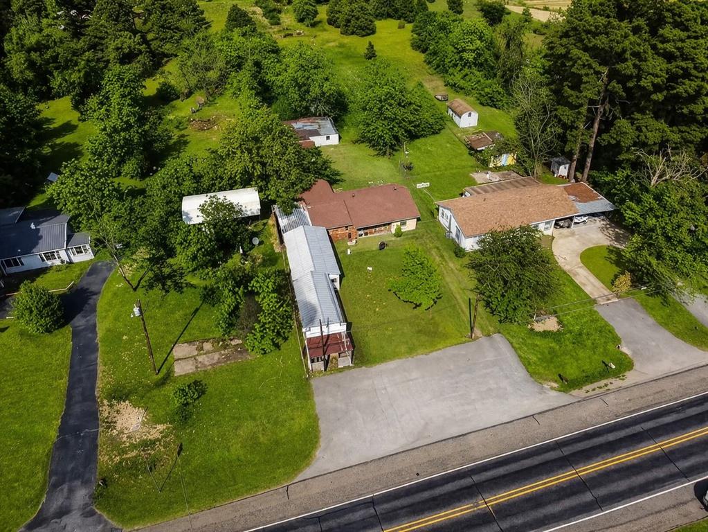 Live where you sell at 22330 State Hwy 64 in Canton, a rare opportunity just minutes from the world famous First Monday Trade Days. This unique property offers the chance to own a 4 bedroom, 2 bathroom home on just over half an acre while also having your own storefront space right on a well traveled highway.

For First Monday vendors, this setup is hard to find. Instead of renting booth space month after month, you could operate your own storefront with excellent visibility and an asphalt parking area that can handle six or more vehicles. The location makes it ideal for anyone wanting a permanent spot to sell antiques, boutique items, tools, collectibles, or specialty goods while living right on the same property.

The home offers just under 1,400 square feet with a practical layout and comfortable living space. A one car side garage with rear access adds convenience, while the workshop space between the storefront and the home includes electricity and creates additional room for inventory, projects, or business storage.

Behind the home, you will also find another powered outbuilding on a slab, along with loafing sheds that could be used for small animals, hobby farming, or additional storage. The property offers flexibility whether your focus is business, homesteading, or both.

Properties that combine residential living, commercial frontage, and proximity to First Monday rarely become available. This is a strong opportunity for vendors, entrepreneurs, or anyone looking for a live and work property in Canton.