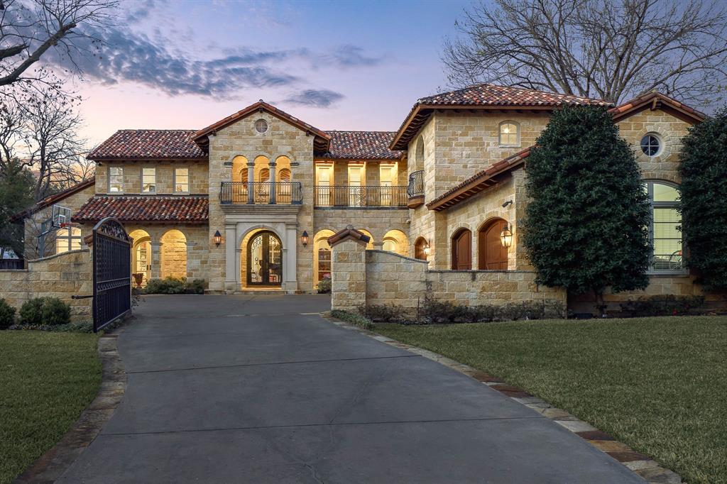 Located on a beautifully landscaped, gated lot of approximately 0.622 acres in coveted Old Preston Hollow, this Mediterranean-style estate offers exceptional scale, privacy, and resort-style living. The expansive 108' x 249' lot features five bedrooms, six full baths, three half baths, and a three individual bay car garage with motor court.

The main level is designed for elegant yet functional living, with an open, flowing floor plan that accommodates both formal entertaining and everyday comfort. Spaces include refined formal living areas, a private library or office, a formal dining room and multiple interconnected gathering rooms.

The gourmet chef’s kitchen serves as the heart of the home, highlighted by dramatic 21-foot ceilings, commercial-grade appliances, an oversized island, and a full bar with a wine room. It opens seamlessly to the keeping room and family room, creating a natural hub for entertaining and daily living.

The first floor includes the primary suite and a guest suite, all with en-suite baths. The primary retreat offers a private sitting room with fireplace, dual spa-like bathrooms, and two expansive walk-in closets. Upstairs, three additional en-suite bedrooms are joined by a large game room with private balcony and a dedicated fitness room.

Outdoor living is a standout feature, with approximately 2,000 square feet of covered spaces, multiple terraces, and two covered patios. The resort-style backyard includes a pool with tanning ledge, spa, fountain, and multiple water features. Heat lamps extend year-round usability in the covered patio, while 12-foot holly hedges provide complete privacy with no sightlines from neighboring properties. This is a rare opportunity to own a private estate in one of Dallas’ most prestigious neighborhoods.