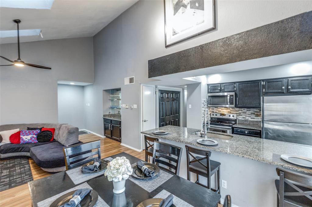 Motivated Seller! Bring all cash offers! This two-bedroom, two-bathroom condo in Vickery Village features high ceilings, wood flooring, and a living area centered around a wet bar and natural light from overhead skylights. The updated kitchen, finished with granite countertops, sleek cabinetry, and stainless steel appliances, opens to a separate dining area and living room with access to a private balcony. The layout includes a dedicated laundry room for a full-size washer and dryer, while the primary suite offers an oversized closet with integrated attic storage access. 2 assigned parking spaces, one covered. HOA includes gas and water. Located minutes from US-75, Park Ln, Northpark and Walnut Hill rail stations, this property provides a functional floor plan and a strong investment opportunity in a highly accessible Dallas location. Seller offering all furnishings within home with acceptable offer!
