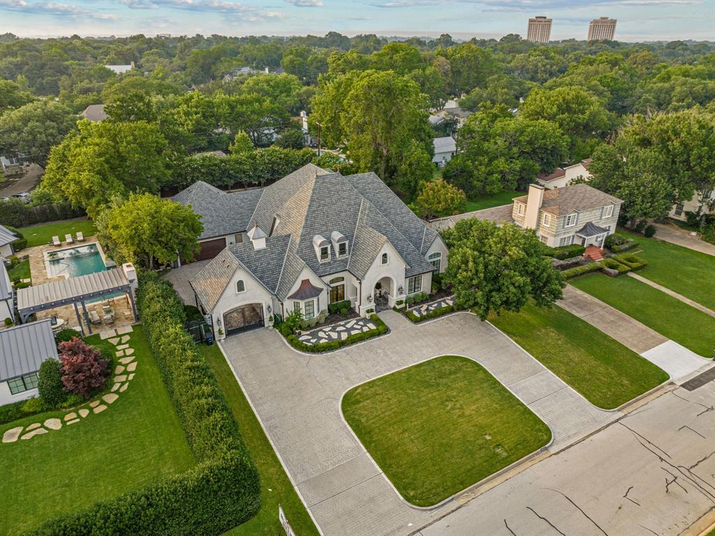 Built in 2014, this luxurious single-story home sits on a 0.50-acre lot, offering over 4,500 sq ft of living space. It features 4 bedrooms, 3 full baths, and 2 half baths. Enjoy the elegance of a formal dining room and the convenience of a breakfast room off the kitchen. The property includes an office, gym, and versatile flex spaces, perfect for extra storage, a second office, or a media room. Entertain outdoors with a fully-equipped kitchen (hibachi grill, green egg), a heated pool, and a hot tub. The spacious backyard has artificial turf and an 8-foot privacy fence. Additional highlights include a port-cochere with a motor court and an oversized 2-car garage. The gourmet kitchen boasts a marble island, Viking appliances, a wine refrigerator, a built-in ice machine, a warming drawer, and a double oven. Luxurious marble details adorn the master suite and half baths. This home is an entertainer's dream and a private oasis.