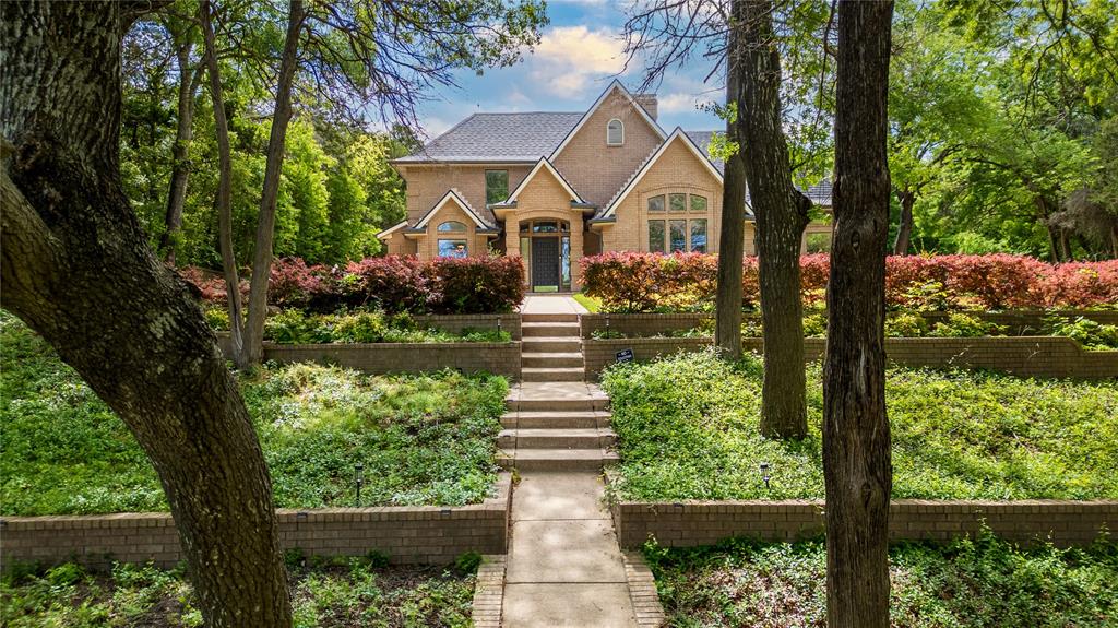 Welcome to your private retreat in the highly sought-after Frost Farms community! Situated on over 1.24 acres, this custom all-brick home offers 5 bedrooms, 4 full bathrooms, and over 3,200 square feet, perfect for those seeking space, privacy, and an acreage property near the Dallas area. The open-concept layout features vaulted ceilings, abundant natural light, hardwood flooring in high-traffic areas, and two wood-burning fireplaces, creating a warm and inviting atmosphere. The kitchen includes double ovens, an electric cooktop, and ample cabinetry, ideal for entertaining and everyday living. A private guest suite with its own ensuite bath makes this home perfect for multigenerational living or extended stays. Upstairs bedrooms include a functional Jack-and-Jill bathroom layout. Enjoy outdoor living on a covered patio with flagstone accents, overlooking a spacious backyard surrounded by mature trees, offering privacy and room to relax or entertain. Additional features include a 3-car garage with side entry, extended driveway, and a 3-zone HVAC system for comfort and efficiency. Conveniently located with easy access to major highways, this home offers the perfect balance of country-style living with city convenience.