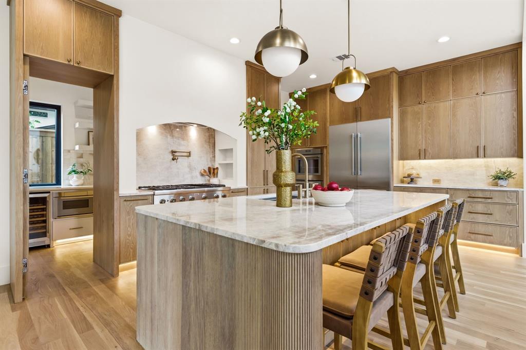 Step into a Newly Completed Home that blends modern design with everyday comfort and standout craftsmanship. From the moment you arrive, the striking brick and stucco exterior, paired with a grand glass pivot entry door and sleek metal-and-glass garage, sets a bold, contemporary tone.
Inside, a dramatic two-story living room filled with natural light creates the perfect space for entertaining, complemented by seamless indoor-outdoor flow through out swing patio door.. White oak flooring runs throughout, adding warmth and sophistication to the open-concept layout.
The chef’s kitchen is a true centerpiece, featuring custom white oak cabinetry, premium Thermador appliances, and a separate butler’s kitchen—ideal for hosting and everyday convenience. A first-floor guest suite or office adds flexibility, while the luxurious primary suite offers private backyard access for a peaceful retreat.
Designed for modern living, the home includes a fully integrated smart home system, built-in audio in key living areas, and dedicated laundry rooms on both levels.
Step outside to your private resort-style oasis, complete with a heated pool and spa, a stunning waterfall feature, outdoor kitchen, and low-maintenance turf landscaping—perfect for year-round enjoyment.
With thoughtful details throughout and high-end finishes at every turn, this home delivers the ideal balance of style, function, and comfort for today’s buyer.