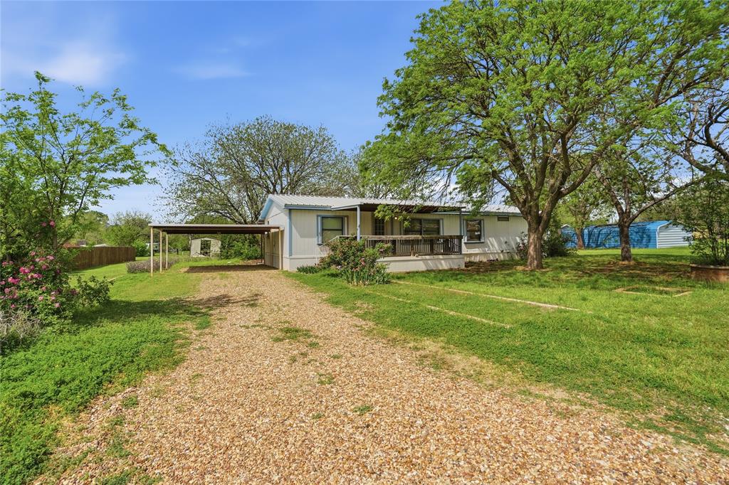 **BACK ON MARKET DUE TO BUYER FINANCING** Located on the Fort Worth side of Granbury, this property offers ideal access to US-377 and convenient commutes to Fort Worth, Weatherford, and surrounding areas. The 3-bed, 2-bath sits on just over half an acre. The home features its original finish-outs, vaulted ceilings, and a spacious layout with two large living areas. The kitchen includes a high-top wrap-around breakfast bar that opens to the main living space for easy gathering. 

Outside, the home offers two generous decks—one in front, perfect for rocking chairs beneath mature pecan trees, and a large back deck overlooking open land with no rear-facing neighbors. The backyard feels exceptionally private with long views to the tree line.