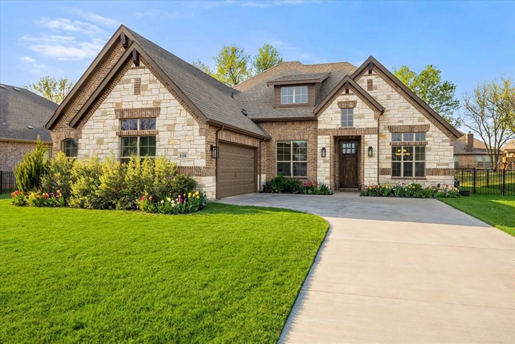 Completed in 2024, this 4-bedroom, 2-bath home delivers a refined take on modern living with intentional design and upgraded features throughout. The striking stone veneer exterior sets the tone, while inside designer touches and thoughtful selections bring fill the home with warmth and character.

Step inside to an inviting living space centered around a beautiful floor to ceiling stone fireplace. The kitchen makes a statement with granite countertops, black cabinetry, and gold hardware, blending bold design with timeless appeal. A separate dining room provides a dedicated space for hosting or a flexible space as a second living area.

The primary suite is spacious and designed as a true retreat, offering a private sitting area, dual vanities, abundant natural light from large windows, a separate tub and shower, and an oversized walk-in closet. In addition, the home offers three secondary bedrooms, one of which is well-suited for use as a home office.

Throughout the home ceramic wood-look tile adds durability and style, and 10' ceilings keep everything feeling open.

Enjoy added value with a whole-home Puragain water filtration system and reverse osmosis drinking water in the kitchen. These features bring long-term comfort and convenience. 

Designer window coverings, ceiling fans, and gutters are already in place, making this home truly move-in ready.

Stylish, functional, and thoughtfully upgraded—this home stands out in all the right ways.