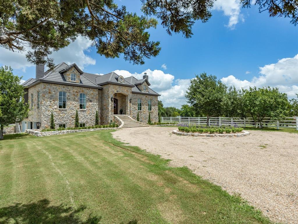 Sophisticated yet livable style full of unexpected touches and timeless details in this SENSATIONAL European Countryside inspired equestrian estate on 9.98 manicured acres with a masterfully built home loaded with next-level craftsmanship and finishes from floor to ceiling!  Gorgeous, double entry doors open to a grand foyer with magnificent marble floors, exquisite moldings and wall paneling, and wonderful natural light that sets the tone for the entire home. Stunning chef's kitchen with commercial grade appliances, built-in side by side Sub Zero, and Carrera marble countertops open to a welcoming keeping room with quaint fireplace and gorgeous wood windows that offer nice views of it's covered back loggia and spectacular pool. The most picturesque setting with pristine, 4 board vinyl fencing, the prettiest mature trees and great hilltop views. Arguably one of the favorite features twill certainly be it's charming 60x30 barn with herringbone brick aisles and ornamental iron detailed stalls with runs that are convenient to an outdoor arena that's 78' X 210'. All 5 stalls have automatic waterers, fans and fly spray system. Back gate access for easy loading and pull thru. Less than 10 min to downtown Weatherford and quick commute to Fort Worth.