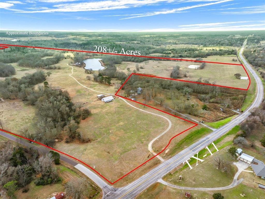 This exceptional 208 acre tract features a stunning 7 acre lake stocked with hybrid bass, complete with a lighted water fountain & fishing pier. A charming log cabin overlooks the lake, offering picturesque views from the large windows & doors opening to the covered deck with spacious hot tub. This peaceful retreat has a large game room, complete kitchen with custom cabinets & countertop. There are two bedrooms, one large bath with walk-in shower, & a loft for the younger folks. The concrete drive circles around a 780 sq ft vaulted carport entrance. The rolling pasture & wooded acreage provide a beautiful blend of open & shaded land, complemented by a productive hay meadow & dedicated hay barn. A 3,500 square foot barn includes working livestock pens, & an upstairs loft ideal for storage & hay. There is a chicken coop, storage container for some rolling stock, & a lean-to for larger equipment. The entire property is newly fenced & cross fenced making it well-suited for agricultural, recreational, or ranch operations. ($120,000 annual revenue) and is ag exempt with minerals available. Located in Winnsboro, Texas - Wood County, and about halfway in between Dallas & Shreveport - Bossier City. This is the perfect place for a Homestead or Homeplace for generations.
