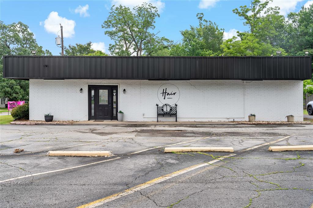 Excellent opportunity to own an established commercial property on over half a city acre! Currently operating as a successful salon, this versatile property offers 11 leaseable booths, a shared reception and waiting area, open space for shampoo stations and dryers, one full bath, and one half bath. With consistent, long-term booth rental income, this property presents an attractive investment opportunity from day one.

Looking for a space for your own business? The property's flexible layout lends itself to a variety of commercial or retail uses. Outside, you'll find ample parking with a convenient circle drive, providing easy access for customers and clients. A 28' x 40' metal shop at the rear of the property adds valuable workspace, storage, or expansion potential.

Whether you're seeking an income-producing investment, a business location, or both, this unique property offers endless possibilities in a highly functional setting. Storm shelter inside the main structure. Additional back entry and covered patio. Schedule your showing today and explore the potential this commercial property has to offer!