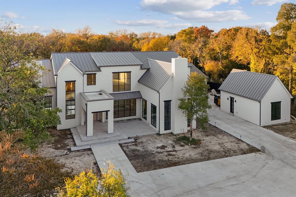 Stunning soft-contemporary home in Bluffview, set on a sprawling 1.6-acre gated lot. This exceptional residence combines luxury, privacy, and functionality, featuring 4 en-suite bedrooms, an office, a library, a gym, a media room, 4 living areas, dual kitchens (a catering kitchen and main kitchen), detached guest quarters, an 8-car garage, a resort-style pool, a basement, a safe room, and more.  

The first-floor primary suite offers breathtaking views of the courtyard and resort-style pool. Its luxurious bathroom features a show-stopping marble tub sculpted from a 4-ton solid marble block, a steam room, double closets, dual water closets, and a private gym. Nearby, the library and office provide a tranquil workspace with views of the beautifully landscaped front yard.  

On the second floor, you’ll find a media room, a wet bar, a spacious game room, and three additional en-suite bedrooms, each designed with comfort and style in mind.  

The outdoor areas are perfect for entertaining and relaxing, with expansive spaces for lounging, a sparkling pool with water features, an outdoor kitchen, and a cozy fireplace. The backyard offers ample privacy and room for a sports court, putting green, and more. The gated front yard is equally impressive, with 170 feet separating the street from the grand front entrance. An oversized circular driveway and private 8-car garage ensure ample space for vehicles and recreational toys.  

Currently under construction, this luxury residence is scheduled for completion in Spring 2025.