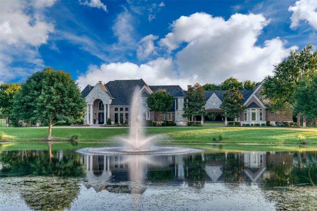 Set on 2.5 pristine acres in the coveted Hills of Buffalo Creek, this extraordinary estate blends timeless elegance with modern luxury. A sweeping circular drive welcomes you with a stunning aerated pond centerpiece, creating a grand first impression that continues throughout the property.
This remarkable 5-bedroom, 9-bath residence has been extensively enhanced with over $200,000 in recent upgrades. The chef’s kitchen showcases premium Wolf appliances, refined hardware, and gorgeous granite countertops, complemented by new windows, flooring, designer fixtures, fresh paint, and custom wood trim throughout the home. Designed for both everyday comfort and elevated entertaining, the main level offers a serene owner’s suite, a private guest bedroom with full bath, an executive study, two spacious living areas, formal dining, breakfast nook, wet bar, utility room, and three fireplaces that add warmth and character. Upstairs, three generously sized bedrooms feature private en-suite baths, alongside a media room complete with kitchenette and an expansive game room with full bath, perfect for hosting family and friends. The backyard is a true resort-inspired retreat. Enjoy an outdoor kitchen, sparkling diving pool and spa, and a luxurious cabana with bath and changing area. A wood-burning fireplace, remote screens, and dedicated HVAC create a year-round outdoor living experience. The oversized four-car garage includes a convenient half bath.
Impeccably maintained and move-in ready, this exceptional property at 1704 Bison Meadow offers refined living in an unbeatable location with convenient access to premier shopping and dining. Located in Rockwall, a sought-after lakeside community just east of Dallas, this home presents a rare opportunity to own a private luxury estate. Schedule your private tour today.