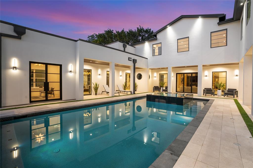 Completed in 2025, this custom-built masterpiece at 5510 Caladium delivers elevated luxury and thoughtful design in one of Dallas’s most sought-after neighborhoods. With over 6,200 square feet, five bedrooms, and striking architectural detail, this home offers both grand entertaining spaces and intimate retreats.

From the moment you enter, you are welcomed by soaring 22-foot ceilings, expansive natural light, and serene pool views. To the right of the entry, a formal living space with fireplace opens to an oversized study with floor-to-ceiling windows. To the left, a sitting area flows into the dramatic great room with 22-foot ceilings and seamless views of the dining and wine rooms. The chef’s kitchen is the heart of the home, featuring a large island, Thermador and Wolf appliances, a Gaggenau espresso station, steam oven, pot filler, wine storage, and a walk-in pantry. Just off the kitchen is a spacious laundry with two stackable washer and dryer sets.

The first floor features a luxurious primary suite with dual walk-in closets, spa-inspired bath, and private outdoor access to a putting green and yard. Another generously-sized downstairs bedroom suite is perfect for guests or intergenerational living.

Upstairs, a lounge leads to the game room with built-ins, a wet bar, and a covered balcony with views of the pool. Entertaining options continue in the media room with Wolf microwave and Thor wine fridge. A powder bath and three additional bedrooms - one ensuite - complete the second floor.

Step outside to a resort-style oasis with sparkling pool and spa, water features, covered outdoor kitchen with Hestan grill, pergola, and multiple seating areas. A three-car garage completes this exceptional property.

5510 Caladium is more than a home - it is a lifestyle, offering the perfect balance of sophistication, comfort, and resort-style living in the heart of Dallas.