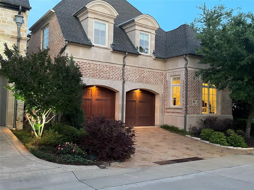 This exceptional home is ideally situated on an interior corner lot within the prestigious, gated community of The Lawn at Glen Abbey, featuring a security-guarded entrance. The thoughtfully designed floor plan offers a first-floor primary suite overlooking a beautifully landscaped greenbelt, along with a separate guest or mother-in-law suite privately located on the opposite side of the home. The chef’s kitchen is equipped with top-tier appliances including a Wolf 8-burner gas range with double ovens, Asko dishwasher, SubZero refrigerator&freezer, and SubZero wine refrigerator. A private office provides the perfect work-from-home space, while the spacious main living and dining areas showcase soaring ceilings and an abundance of natural light with views of beautiful, mature landscaped greenery. Upstairs, enjoy a second media or game room and two additional bedrooms. Additional highlights include an elevator equipped closet, ample storage throughout, and a covered brick patio off the main living area - ideal for entertaining or enjoying a quiet, private retreat.
