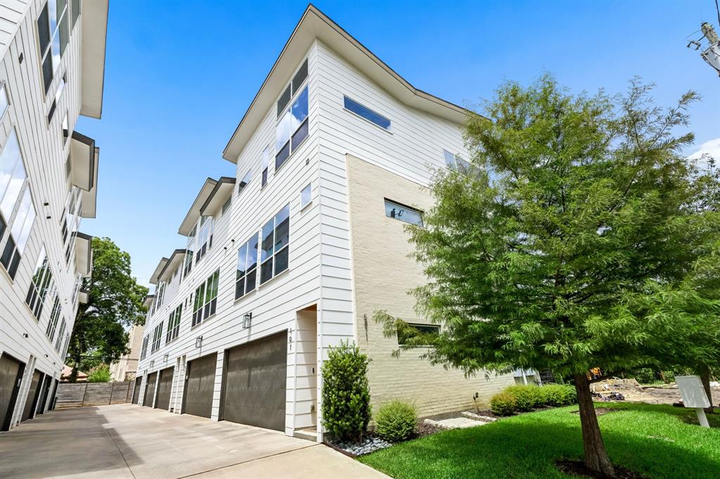 Enjoy low-maintenance living in this stunning modern condo just steps from Lower Greenville. Built in 2018, this three-story home showcases quality craftsmanship with hardwood floors throughout, oversized windows, soaring ceilings, abundant natural light, and freshly painted neutral paint throughout. The open-concept second level is designed for effortless entertaining, featuring spacious living and dining areas alongside a chef-inspired kitchen with an oversized island, granite countertops, floor-to-ceiling cabinetry, soft-close doors and drawers, white tile backsplash, pendant lighting, Bosch stainless steel appliances, gas cooktop, and oven. A conveniently located half bath completes the main living level. Upstairs, the impressive third floor features a luxurious primary suite with a a spa-like ensuite bath and a large walk-in closet. The secondary bedroom offers flexibility as a guest suite or home office and includes a closet and private ensuite bath. The oversized two-car garage features durable epoxy flooring and extra space for a home gym or additional storage. Outside, enjoy a private, landscaped backyard with turf and a patio—perfect for relaxing or entertaining. Ideally located just steps from all the dining and shops of Lower Greenville and minutes from Downtown Dallas, this home offers the perfect blend of walkability, convenience, and lock-and-leave living in one of the city's most vibrant neighborhoods.
