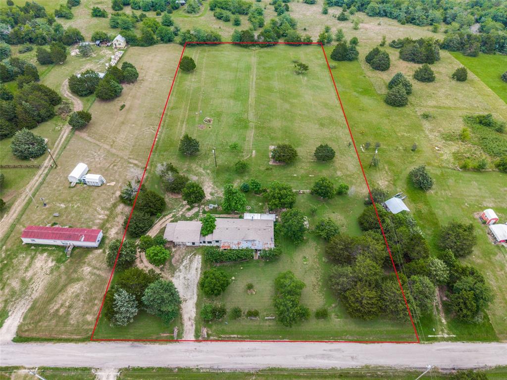 Enjoy quiet, peaceful living on four beautiful acres in Point, Texas, where small-town charm, friendly neighbors, and community pride are simply a way of life. Spend your mornings watching deer wander through the backyard, relax beneath the shade of the mature pecan trees, or unwind on the porch while soaking in the peaceful sounds of the country. If you've been dreaming of the lake life, both Lake Tawakoni and Lake Fork are just a short drive away, offering endless opportunities for boating, fishing, and making memories with family and friends.

The expansive front porch welcomes you home and is the perfect place to enjoy your morning coffee. Inside, this 3-bedroom, 2-bath home offers a spacious primary suite complete with an ensuite bathroom, while the secondary bedrooms share a full bath. The comfortable living room is filled with natural light and opens to an enclosed sunroom, allowing you to enjoy the beautiful views of your property no matter what the Texas weather has in store.

The kitchen offers plenty of cabinet and countertop space, making meal preparation easy while staying connected to family and guests. Just outside, you'll find plenty of room for gardening, raising animals, or creating the outdoor retreat you've always imagined.

If you've been searching for room to breathe, peaceful surroundings, and a place where life moves at a slower pace, this property offers the perfect opportunity to enjoy country living while still being conveniently located to nearby shopping, dining, and all that East Texas has to offer.