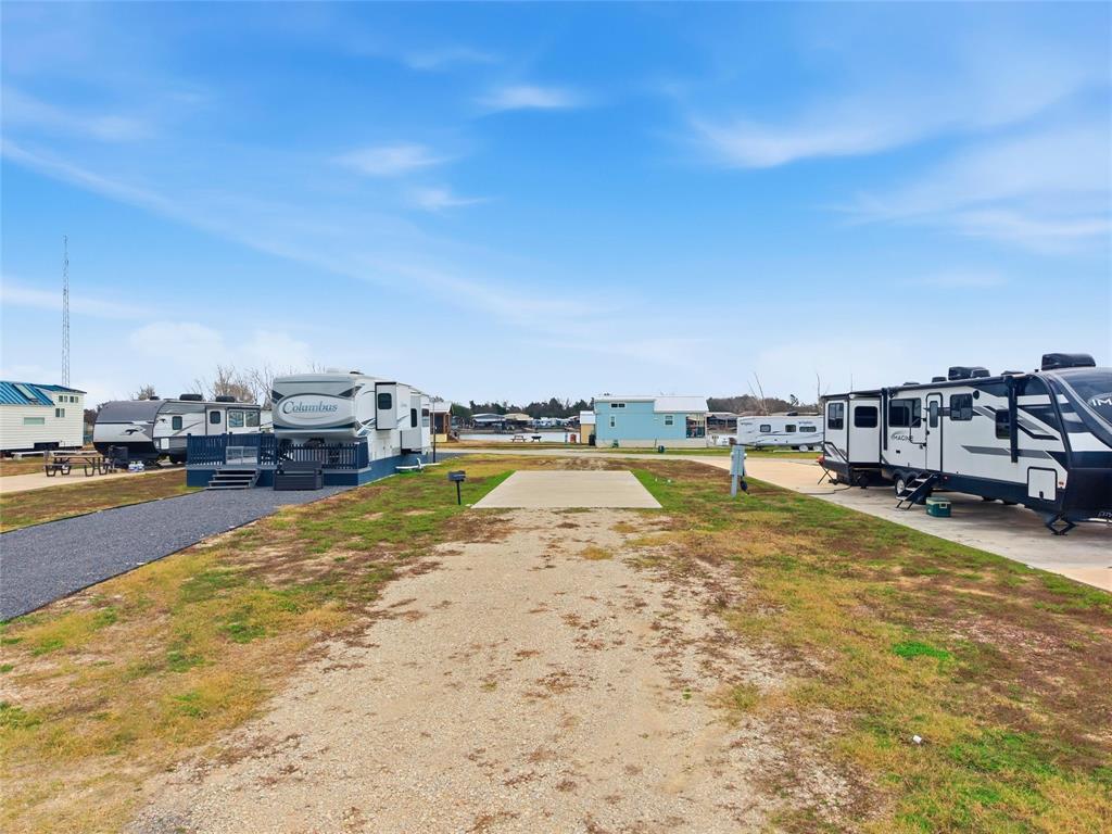 Located inside a gated lake community on Richland Chambers Lake, this interior lot is ready for RV retreat with water and electric already in place. The property is cleared and easy to maintain, making it a simple way to enjoy weekends at the lake or create a low maintenance getaway. Just a short distance from community amenities, you can spend your time fishing, swimming, or relaxing by the pool and clubhouse. Whether you are looking for a personal escape or a place to unplug and recharge, this lot provides a convenient and inviting setting for relaxed lake living.