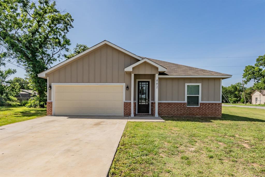 Experience beautiful contemporary luxury in this stunning 4-bedroom, 2-bath Cleburne home. Spanning 1,641 square feet of elegantly designed living space, this residence commands attention starting with its captivating exterior curb appeal. Step inside to an inviting living area where sophisticated style seamlessly flows into the expansive gourmet kitchen, complete with a grand island and premium stainless steel appliances. The private primary suite features an en-suite bathroom that epitomizes luxury, boasting dual vanities, a spa-like soaker tub, and a spacious separate shower. Enjoy ultimate outdoor relaxation on the covered back patio porch. Perfectly positioned for families, this home sits directly across the street from a neighborhood playground, blending upscale design with unbeatable everyday convenience.