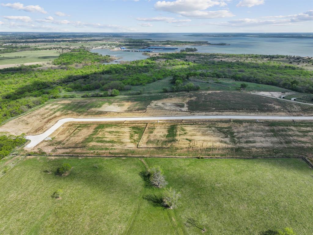 Extremely pleased to offer the most BREATHTAKING property offered in our 20-year history. 180-degree lake view & you can see for miles of Lake Ray Roberts. The sunsets to the West are incredible with cool breezes coming off the lake. Sunrises to the east are equally impressive, rising over the lake. It adjoins the Army Corps of Engineers, which encompasses over 440 acres of nature to explore, and preserves the natural shoreline. Approximately a 2-mile drive to the marina, 10 minutes to the 20-mile walk and horse trails, and 5 minutes to hunting land.