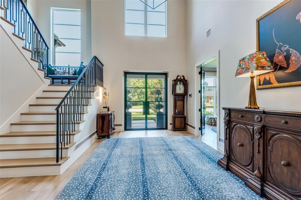 Welcome to this stunning, high-quality Chris Sandlin home completed in 2023, ideally situated in the highly sought-after Midway Hollow neighborhood. Designed with timeless style and modern comfort, this home impresses from the moment you arrive. Expansive windows and large sliding doors create a seamless connection between indoor and outdoor living spaces, flooding the home with natural light and offering serene views of the beautifully landscaped yard. The open floor plan is perfect for both everyday living and effortless entertaining. The spacious living and dining areas flow into the chef’s kitchen featuring a large island with waterfall quartz countertops, premium KitchenAid appliances including a built in refrigerator and a 6 burner gas cooktop, and a gorgeous butler’s pantry equipped with a built-in wine cooler, sink and wine rack. The downstairs office has lots of natural light and a closet making it perfect for working at home.  The first-floor primary suite is a true retreat, offering peaceful garden views and a spa-inspired bathroom with luxury finishes. Upstairs, a generous living area accompanies four spacious bedrooms and three full baths—perfectly suited for family and guests. Step outside to an exceptional outdoor living space complete with a built-in grill, refrigerator, sink, retractable screens, fireplace, TV, mosquito misting system, and thoughtfully designed landscaping. Additional upgrades include a Generac whole-house generator, Hunter Douglas electric window coverings, oversized garage with epoxy floors, electric car charger, cabinetry, and motorized storage lift. Every building detail has been thoughtfully considered including 2x6 exterior walls, foam encapsulation and whole house pest control. This home blends designer style, quality, comfort, and function. This is a rare opportunity to own a meticulously crafted home in one of Dallas’s most desirable neighborhoods.
