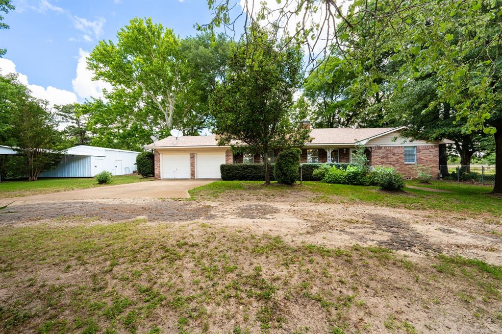 Charming 3 Bedroom Farmhouse on 1 Acre with Shop & Additional 21.659 Acres
Welcome home to this beautifully updated 3 bedroom, 2 bath farmhouse, set among mature shade trees that line the circle drive & create a truly inviting first impression. This well maintained property blends classic country charm with thoughtful updates, offering comfort, functionality, & room to grow.
Step inside to an updated chef’s style kitchen featuring modern appliances, generous counter space, and stylish finishes—ideal for cooking, hosting, & gathering. The cozy living area is anchored by a wood burning fireplace, creating the perfect atmosphere for quiet evenings or family time. Both bathrooms are partially updated with new flooring.
The home includes a 2 car garage plus additional covered parking at workshop & a detached carport that will convey with the sell.  There is a fenced backyard for all your fur babies.  A 20 kw whole home generator that is tied into the side yard above ground propane tank.  The Generator is not currently operable.  Homeowner states that it is possibly the motherboard.  The home was completely rewired approximately 12 years ago, replacing the aluminum wiring with copper for added safety & reliability.
A large shop sits just to the left of the home—ideal for equipment, hobbies, storage, or small business use. The home itself sits on 1 acre, with an additional 21.659 hay producing Ag Exempt acres that are included in the listing.  The acreage is fenced with mostly 6 strand barbed wire fencing.
There is a previous 2nd homesite area on the property that has water, electric, & a conventional septic system.  The mobile home was removed approx 6 years ago, but the infrastructure remains.
Buyer & Buyers Agent to verify all information.