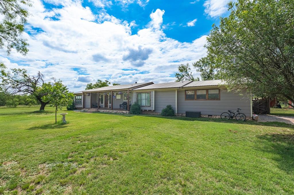 Spacious and Secluded 4 bedroom, 3 bath home on 5.8 acres with a 1 bed, 1 bath income producing property approximately 100yds behind the house.  The home has a beautiful landscape about it with sprawling, mature mesquites.  There are two large primary suites with bathrooms along with two other spacious bedrooms sharing a Jack and Jill bath. The large living room with a wood burning fireplace as the central hub for family gatherings and entertaining guests.  If being outside is your thing, enjoy the front deck with your morning coffee or evening night cap.  The property has approximately a 1 square acres spot with posts set, ready for fencing.  The above ground pool in the backyard conveys.  The carports offer covered parking as well as a small secluded drive to the small home in the back.  Air BnB clients get a very quiet, secluded experience.  This property offers many avenues between a future horse property, homestead or income producing capabilities.  The chicken coupe will convey as well as the chickens.