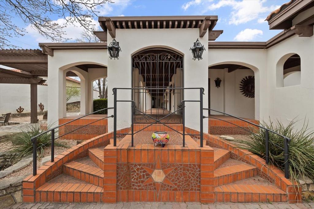 Experience the quintessential Mediterranean lifestyle in this stunning waterfront estate, perfectly perched on a nearly acre-sized lot (0.81 acres) on Eagle Mountain Lake. The architecture captures a timeless European elegance, blending classic stucco finishes with the breezy, indoor-outdoor flow characteristic of coastal Italy and Spain. With 3,570 square feet of refined living space, this 3-bedroom, 2.5-bathroom home offers expansive views of the water. From the private, gated-feel to the outdoor entertainment area, this is a 'trophy property' designed for both grand entertaining and quiet, sun-drenched retreats. Bonus waterfront Casita providing a versatile 'getaway' space right at the water’s edge. Whether you’re hosting guests in the main house or enjoying a sunset cocktail from the casita porch, the seamless indoor-outdoor flow and classic Mediterranean styling make this property a true waterfront gem in Twin Points West.