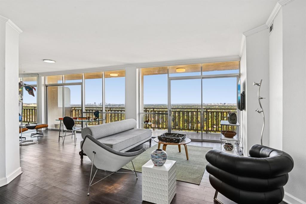 Welcome to this stunning corner residence in Preston Tower, an iconic mid-century modern high-rise in the heart of Preston Hollow. This beautifully updated 2-bed, 2-bath end unit offers sweeping north-facing views across Preston Hollow, showcased through wall-to-wall windows and a spacious 30-foot balcony that fills the home with natural light and creates a seamless connection to the outdoors.  The thoughtfully designed floor plan maximizes both space and functionality, with generous closet storage throughout. The open kitchen has been expanded with a pass-through and pantry, offering abundant cabinetry and flowing into the dining area, where a charming breakfast bar provides additional seating. The spacious living room also includes a versatile nook near the entry, perfect for a home office.  Rich wood floors add warmth and continuity throughout the home, while tasteful finishes create a refined, timeless aesthetic. The guest bath features warm neutral tones and a frameless glass walk-in shower. In the primary suite, you'll find exceptional storage with deep closets and a freestanding wardrobe, along with an en-suite bath finished in elegant travertine and mosaic tile. The unit also includes in-unit washer and dryer connections for added convenience.  Enjoy a true lock-and-leave lifestyle with HOA dues that cover all utilities, Wi-Fi, internet, and U-Verse service for one TV. Preston Tower offers an impressive collection of resort-style amenities, including a pool, a fire pit, pickleball and tennis courts, a fitness center, a library, a dog park, and 24-hour security. Residents also enjoy the convenience of a coffee shop in the lobby and the retro charm of Bernie's, the perfect spot for evening cocktails.  Located directly across from Preston Center, you'll be just steps from upscale shopping, dining, and everyday conveniences. This exceptional residence offers the perfect blend of mid-century character, modern updates, and an unbeatable Preston Hollow location.