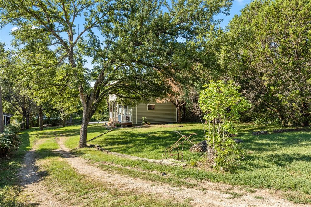 Lake Life Awaits—Just Minutes from Granbury’s Historic Square!
Step into the ultimate lakeside retreat! This charming, custom-built cottage sits just seconds from the main body of Lake Granbury, offering the perfect blend of relaxation and adventure. Sold fully furnished with everything included, all you need to do is pack your bags and start enjoying lake life.
Sip iced tea on the porches, take in the peaceful surroundings, and let the cottage accommodate your family and friends comfortably. Recent upgrades include a remodeled boat dock (2024) and a new roof (2025).
Want even more space? The lot next door is also available (MLS#21215423) and could be used for a large outdoor entertainment area or a second cottage. Affordable lakefront living has never been this effortless—your little piece of paradise is ready and waiting!