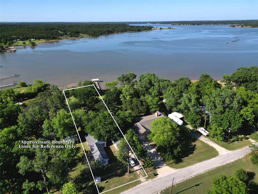 Escape to your peaceful waterfront home on Lake Nocona. This cute 2 bedroom, 2 bath lake house offers stunning water views with direct access to fishing, boating and swimming. This property sits on nearly half an acre, featuring a lush, tree filled lot with a huge backyard that extends straight to the water's edge. This home features a durable metal roof and has been well maintained, offering peace of mind for its next owner. Inside you'll find a cozy layout with comfortably sized bedrooms and 2 full sized bathrooms. Plus, a 25x50 shop provides ample space for hobbies, storage or all your water toys. Perfect for small families, retirees or a relaxing weekend getaway. Enjoy the gentle lake breezes, wildlife and tranquility of lake life. This lake house is true gem in a well established community! Property has recent inspection report.