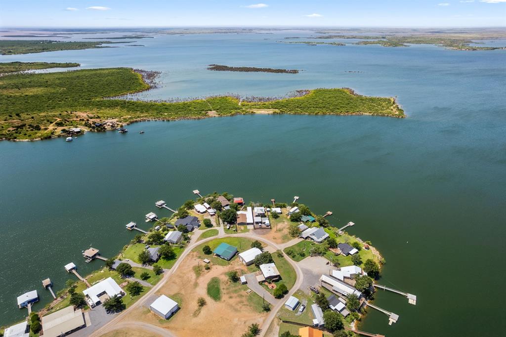 Furnished Lake Kemp waterfront home in gated Moonshine neighborhood! Sleeps 10 easily with 3 large bedrooms, 2 full baths, with panoramic views and private dock. Brand-new roof, central AC, central heat, range, oven, dishwasher, washer and dryer included. Spacious deck with grill, carport. HOA $100 per year. Moonshine neighborhood is on long-term lease from Waggoner Ranch. Furnishings can be removed, buyer's preference. Harris Flotebote 250 Grand Mariner with hydrolift available separately.
