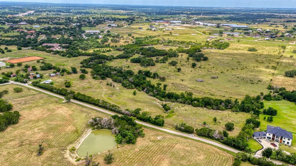 APPROXIMATELY 63 ACRES OF PRIME, UNIMPROVED LAND WITH OWNER FINANCING AVAILABLE! Discover the perfect blend of opportunity and natural beauty with this property. Featuring rollin terrain and varied elevations, this property offers multiple stunning homesite options with scenic views in every direction. With ample road frontage, access is convenient and potential is strong to create the ranch of your dreams. The land is well-suited for agricultural use, currently supporting livestock and benefitting from an existing Ag exemption. Enjoy the added appeal of a natural water feature in the meandering seasonal creek, enhancing both the landscape and functionality for ranching or recreational use. Ideally located halfway between Weatherford and Granbury, and just 30 minutes from Fort Worth, this property offers peaceful country living with quick access to city conveniences. It also backs up to SILVERADO ON THE BRAZOS, making you very near one of the best equestrian centers in the State of Texas. Owner financing makes this property even more enticing for family or investor!