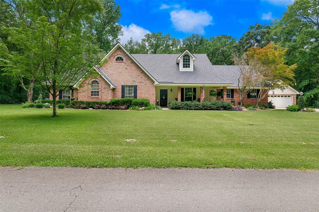 The quiet country living in Holly Ridge Subdivision on this 1.7 acre lot is accessed through Dogwood Subdivision. There is room for everyone in this updated 5 bedroom, 3 and a half bath home, plus a large office-hobby room, with a 2-car attached garage and an oversized 2 car detached garage-workshop.  Granite countertops in bathrooms and laundry room. The front yard has 301 feet of road frontage. The large, updated kitchen has stainless steel appliances with room for 6 barstools at the snack bar. The huge bonus room upstairs has a large closet and full bathroom and is being used as a bedroom and living area. The walk-in attic has abundant storage area.