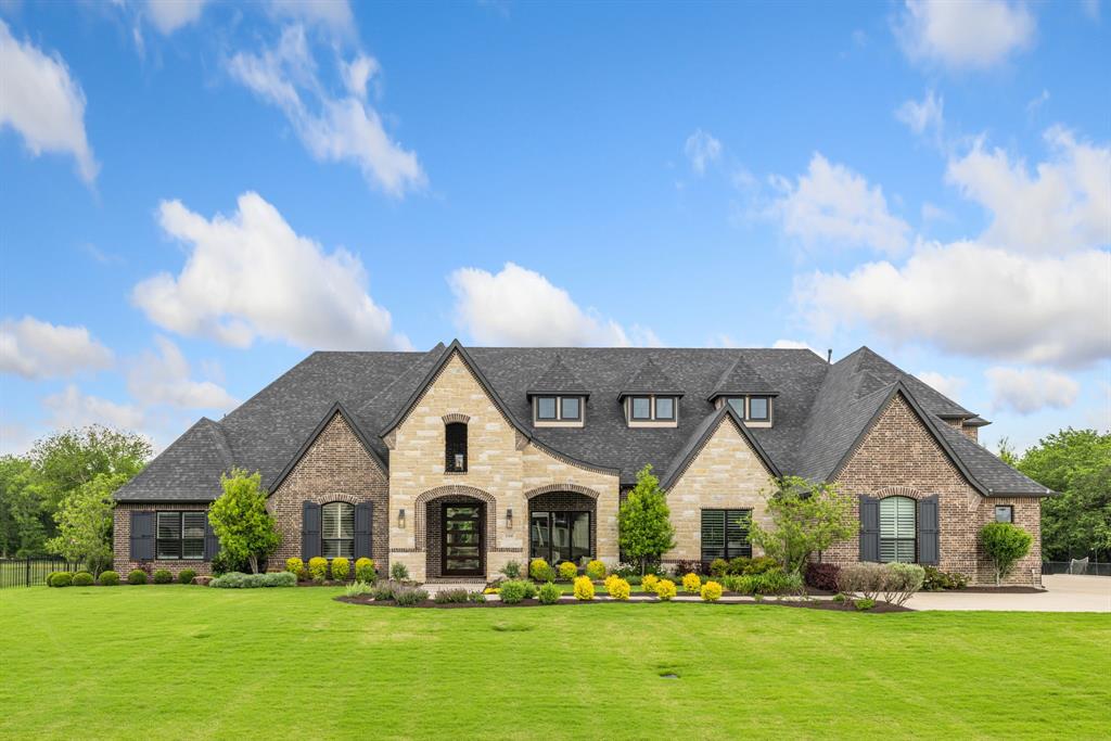 This custom-built home is situated on a rare 3.1-acre private, tree-lined lot in the highly sought-after Lovejoy ISD. A refined blend of luxury, design, and serenity, from the moment you step through the custom Mahogany pivot door, you’re greeted by a light-filled, open floor plan, soaring ceilings, and rich hardwood floors that flow throughout. This thoughtfully designed home offers 6 spacious bedrooms, 5 full and 2 half baths, including 4 ensuite bedrooms, ensuring comfort and privacy for all. The chef’s kitchen is a true showstopper, featuring dual oversized islands, granite and quartzite countertops, Blanco sinks, and a tucked-away prep kitchen—ideal for effortless entertaining. Enjoy casual and formal gatherings alike in the expansive living room, highlighted by a bold 49” wood-burning fireplace and a stunning cold rolled steel feature wall. The game room, media room, and wet bar provide ample space for recreation and relaxation. The luxurious primary suite offers a peaceful retreat with a groin ceiling, arched windows, automated shades, and backyard views. The spa-inspired primary bath boasts heated floors, a rain shower with six body sprays, and a 72-inch soaking tub, with dual custom closets—hers with direct access to the laundry room that doubles as a reinforced storm shelter. Step outside into a private outdoor paradise, complete with travertine decking, a built-in kitchen, resort-style pool and spa, and a firepit with custom fire sphere. Surrounded by professional landscaping and ambient lighting, the outdoor space is perfect for year-round enjoyment. Additional features include a 4-car garage with epoxy floors and dedicated RV bay, Tesla charger, whole-house generator, water softener, integrated smart home AV system, and surround sound.
This exceptional property offers more than just beauty—it provides a lifestyle of ease, sophistication, and privacy, making it a truly rare find.