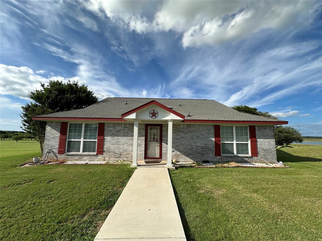 Adorable lake front 2 bed 2 bath brick home on Lake Comanche just a few miles South of Comanche in the gated community of Mercer's Preserve. This property has been well maintained and has a newly constructed detached oversized garage. Gorgeous mature Live Oak trees and beautifully manicured yard. Sprinkler system, aerobic septic, insulated well house, and a full length covered back porch that faces North so that porch can be enjoyed all throughout the year.