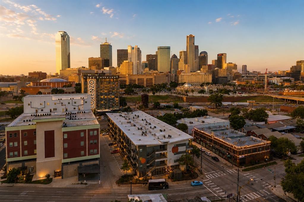 A true urban loft experience in the heart of Dallas! Located in The Cedars, just south of Downtown, Buzz Lofts was designed for flexible modern living. This rare north corner two-bedroom, two-bath residence embraces authentic loft-style architecture with expansive open spaces, soaring industrial vibes, and incredible Downtown skyline views. The airy open-concept layout offers the freedom to create living spaces that evolve with your lifestyle. Whether designed for entertaining, working from home, or more defined bedroom arrangements, the flexible floor plan allows owners to personalize the home while maintaining the signature loft aesthetic. One of the home’s standout features is the oversized garage-style door that opens directly to the  patio, creating seamless indoor-outdoor living and bringing in natural light and city energy. The north-facing orientation captures some of the best Downtown Dallas views in the building. Enjoy secure gated garage parking with two reserved tandem spaces, quick elevator access, and convenient Amazon hubs located on each floor. And, The Cedars continues to emerge as one of Dallas’ most creative and connected urban neighborhoods, known for its art scene, local breweries, music venues, restaurants, and quick access to Downtown, the Farmers Market, Bishop Arts, Deep Ellum, and major highways. If you are seeking something more more fun, flexible, and full of personality rather than cookie-cutter, this is the place for you!