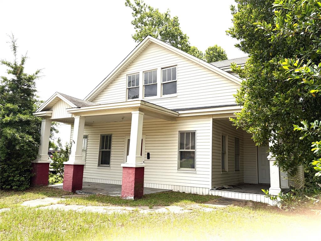 This 1.5 story 4 BR 3 BA craftsman style home has so much potential! It is located right behind the First Methodist Church in downtown Minden. It is about about  a 2 minute walk to Minden Medical Center and downtown Minden. You can walk to the library, downtown with nice restaurants and places to shop. The grocery store and pharmacy are about a ten minute walk. It is a great location if you want to be in the center of things! When you open the front door you enter the Living Room with pretty staircase leading to the upstairs. There is a dining room with faux fireplace that could also be the living room that is located right by kitchen. The primary bedroom has a large walk-in closet and bath that is located downstairs. There is also another room that could be a 5th bedroom or office that has a door that open on to the side porch. Upstairs are three bedrooms and bathroom with old fashion claw foot tub. The lot is approx.130x70.Please call today to schedule your showing! This home would make a great bed and breakfast!!! SOLD AS-IS