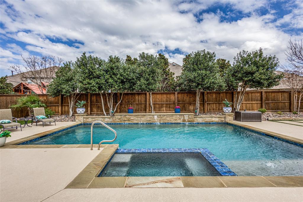 Seller is providing an incentive to lower the initial mortgage rate to 5.75% for qualified buyers using our preferred lender, providing you financial breathing room to ease into this stunning dream home! Welcome to your private retreat designed for unforgettable gatherings, sunny pool days, and effortless everyday living. This meticulously maintained, model-like home offers the perfect blend of luxury and comfort for family and friends to enjoy year-round. Step outside and dive into your own backyard oasis, featuring a sparkling pool, covered patio with automatic screen, and plenty of space to relax, entertain, or let pets and kids play freely in the huge yard. Whether it’s weekend barbecues or evening swims, this home was made for making memories. Inside, the home impresses with soaring ceilings, plantation shutters throughout, and high-end finishes at every turn. The open-concept kitchen is the heart of the home, showcasing a large island, abundant cabinetry, and seamless flow into the dining area where a stunning chandelier overlooks the pool. Designed with flexibility in mind, a private wing offers two bedrooms, a full bath, and a separate game room or living space perfect for guests, teens, or multigenerational living. Movie nights come to life in the state-of-the-art Savant media room, delivering a true theater experience without leaving home. The primary suite is a peaceful retreat, featuring a spacious bedroom, spa-like bath with separate vanities and dedicated cosmetic space, plus a custom closet with built-ins and direct access to the laundry room.
Car enthusiasts and organizers alike will appreciate the three-car garage with epoxy flooring, built-in cabinets, and extensive storage.
Located in a vibrant community with resort-style amenities including multiple pools, fitness center, parks, playgrounds, restaurant, and a scenic lake all just a short walk to highly sought-after Prosper ISD schools, this home truly offers the best of lifestyle and location.