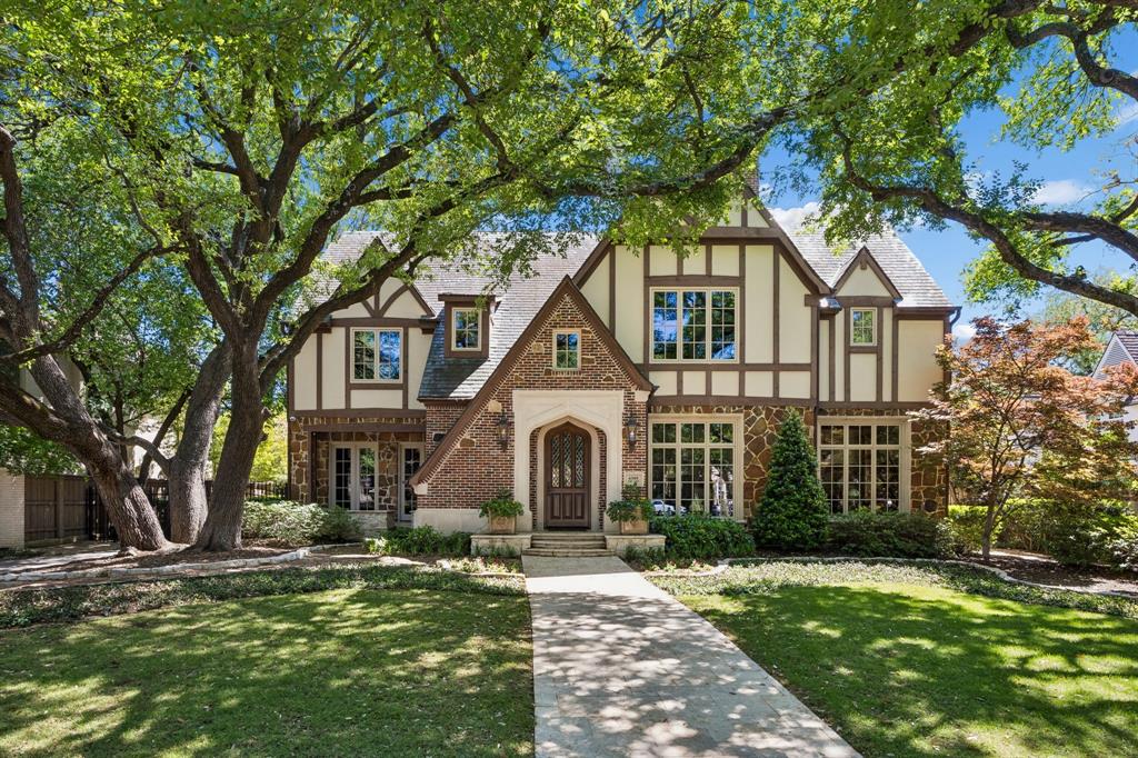 Situated on an impressive 90-foot lot in the heart of the French Streets, this gorgeous Tudor-style residence built by Tatum Brown offers an exceptional blend of architectural distinction and craftsmanship. Surrounded by mature live oak trees, the home features a stunning entry and staircase complemented by exquisite moldings, detailed millwork, and hand-scraped hardwoods.  The main level includes a formal living room with a striking stone fireplace and a dining room with a 300-plus bottle wine closet. Designed for entertaining, the open kitchen comes with stainless Viking appliances, granite countertops, island, built-in refrigerator, and a walk-in pantry. A breakfast room and wet bar flank the kitchen. French doors lead to a loggia overlooking a pool and spa surrounded with Oklahoma flagstone. Completing the first floor are a guest bedroom, full bath, and an impressive office with beautiful coffered ceilings and views of the front yard.  The second level houses a very spacious and luxurious primary suite with a sitting area—suitable for a study or nursery—and a covered balcony overlooking the pool. The primary bath includes separate vanities with marble countertops, an oversized marble shower, and his and her walk-in closets. All secondary upstairs bedrooms feature ensuite bathrooms and walk-in closets, while a third-floor media room offers flexibility as a sixth bedroom. A separate guest quarters above the 3-car garage and a cabana with a full bath provide an additional 958 square feet, bringing the total to 8,197 square feet of air-conditioned space. High-end details and amenities such as a slate roof, copper gutters, porte-cochere, electric gate, laundry room, mud room, elevator, and covered outdoor kitchen round out this remarkable property.