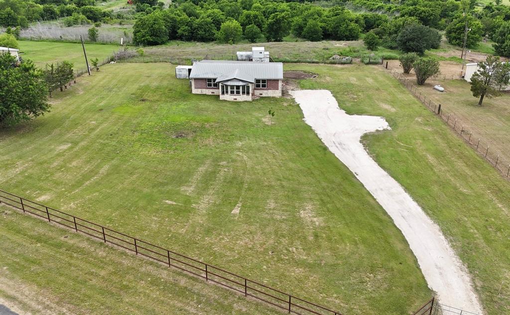 Peaceful Country Living on Over 3+ Acres in the highly desired Godley Independent School District! If you’ve been dreaming of space, privacy, and the freedom to create your ideal rural lifestyle, this property checks all the boxes — and with NO HOA, the possibilities are endless. Bring your horses, RVs, workshop plans, hobby farm animals, and all the outdoor toys with room left to spare. Set back from the road behind attractive pipe fencing, the property offers a quiet, secluded feel with beautiful open space and mature trees that create a relaxing country atmosphere while still being conveniently located near town amenities. (Just a short drive to easy access the Chisholm Trail Parkway) The home features 3 bedrooms along with recent updates including fresh paint and newer flooring, making it move-in ready and easy to enjoy from day one.  The brick & stone home has a pier and beam foundation with concrete footers. The oversized covered back porch is the perfect spot to unwind, entertain guests, or take in peaceful Texas sunsets and wide-open skies. A durable METAL ROOF adds both character and long-term value! Whether you want a comfortable place to settle down now, room to expand later, or acreage to turn your vision into reality, this property offers the flexibility, charm, and country lifestyle you’ve been searching for. Want more space? Additional acreage & house is available for sale right next door MLS # 21264861