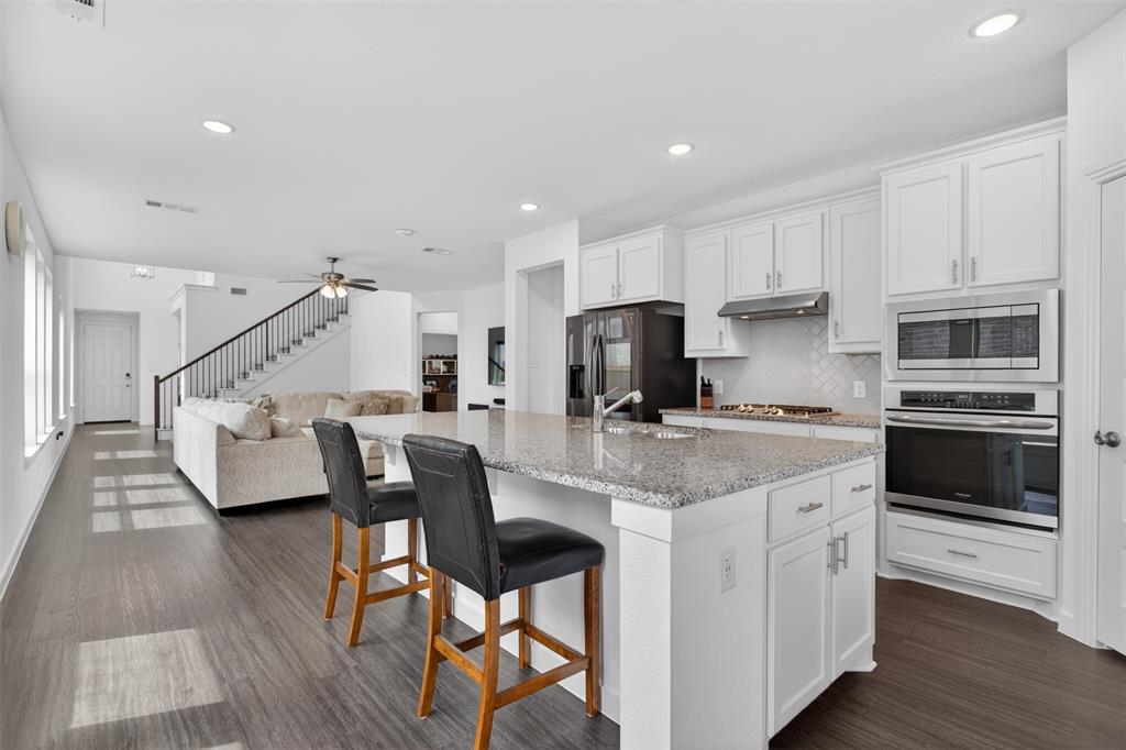 Welcome to this beautifully maintained home in the highly sought after master planned community of Devonshire, where resort style living and everyday convenience come together perfectly. From the moment you arrive, you will notice the pride of ownership and meticulous care throughout this gently lived in home.

Inside, the open concept layout is filled with natural light and designed for both entertaining and everyday living. Durable and stylish LVP flooring flows through the main living areas, offering the perfect combination of beauty, resilience, and low maintenance living. The spacious kitchen is truly the heart of the home, featuring abundant cabinetry, granite countertops, stainless steel appliances, a large island with seating, and seamless flow into the living and dining spaces. Soaring ceilings and an open upstairs overlook create an airy feel that makes the home feel even larger.

The oversized living areas provide incredible flexibility, including a spacious upstairs game room or second living area perfect for movie nights, a playroom, or home office setup. The private primary suite offers a relaxing retreat with dual vanities, a large walk in shower, and generous storage space. Step outside to enjoy the covered patio and spacious backyard with plenty of room to relax, entertain, or play.

Living in Devonshire means access to some of the area’s best amenities including multiple ponds, two community pools, a basketball court, sand volleyball pit, greenbelts, walking trails, and beautifully maintained common spaces that make this neighborhood one of Forney’s most desirable communities. Conveniently located with easy access to shopping, dining, schools, and Highway 80, this home truly checks all the boxes.